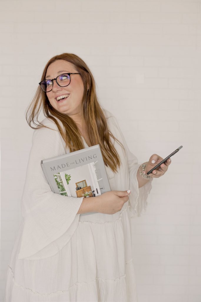 Rocio sujetando un iPhone y un libro en estudio branding diseño y desarrollo web valencia